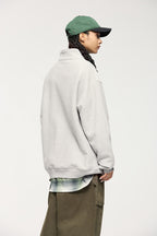 Sudadera con capucha y media cremallera